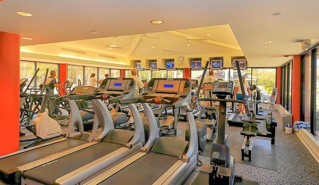 gym featuring ceiling fan, recessed lighting, and expansive windows