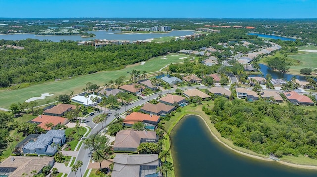 drone / aerial view featuring a water view, golf course view, and a residential view