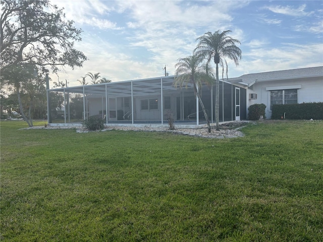4411 Dolphin Ln, Palmetto, FL 34221 - rear view of house featuring a lawn and glass enclosure