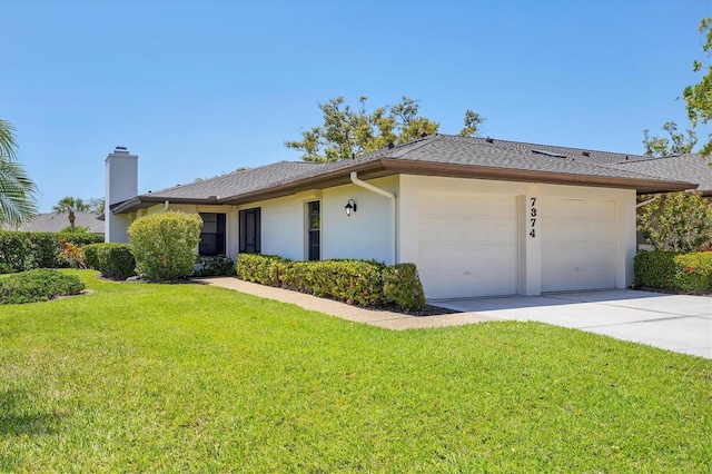 7374 Royal Birkdale Dr Unit 15D, Sarasota, FL 34238 - ranch-style house with driveway, a chimney, a front lawn, an attached garage, and stucco siding
