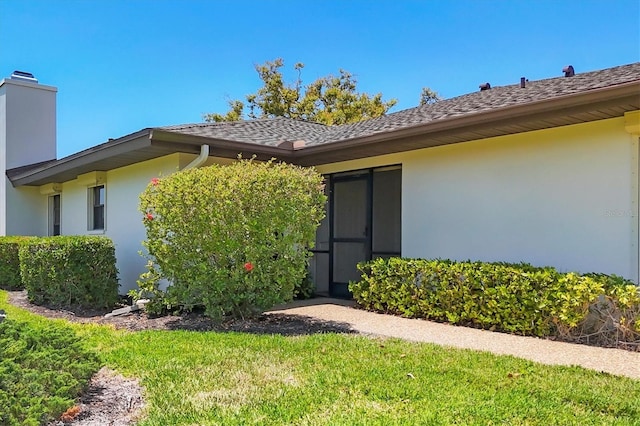 7374 Royal Birkdale Dr Unit 15D, Sarasota, FL 34238 - entrance to property with a yard, a chimney, and stucco siding