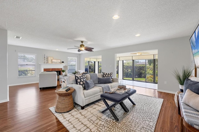 7374 Royal Birkdale Dr Unit 15D, Sarasota, FL 34238 - living room with visible vents, a ceiling fan, a textured ceiling, and baseboards