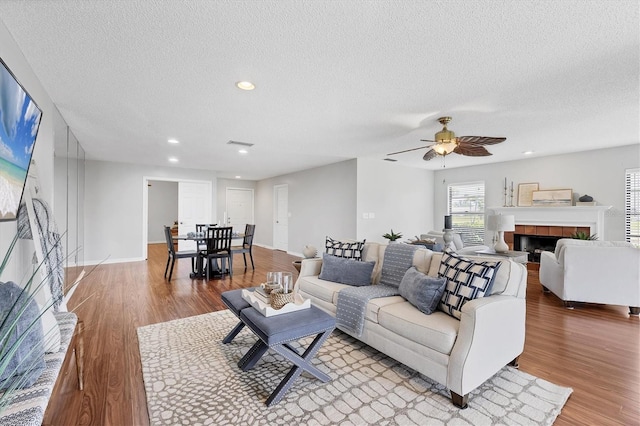 7374 Royal Birkdale Dr Unit 15D, Sarasota, FL 34238 - living area with recessed lighting, a ceiling fan, a textured ceiling, and light wood finished floors