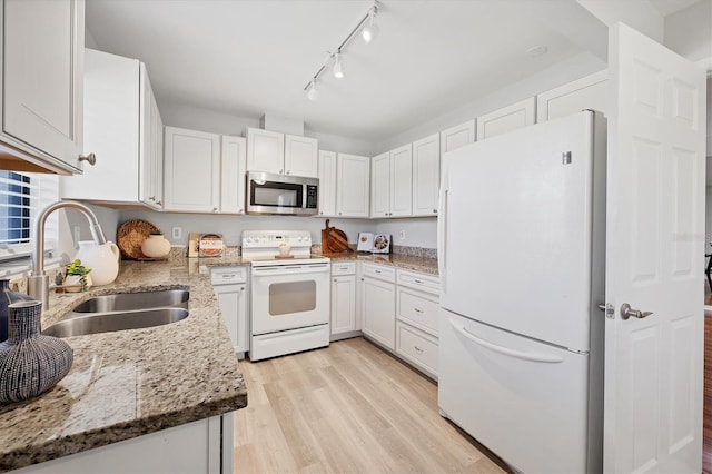 7374 Royal Birkdale Dr Unit 15D, Sarasota, FL 34238 - kitchen featuring white appliances, light stone countertops, light wood-type flooring, white cabinets, and a sink