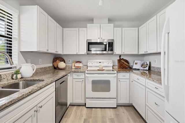7374 Royal Birkdale Dr Unit 15D, Sarasota, FL 34238 - kitchen with a sink, stainless steel appliances, light wood-style flooring, and white cabinetry