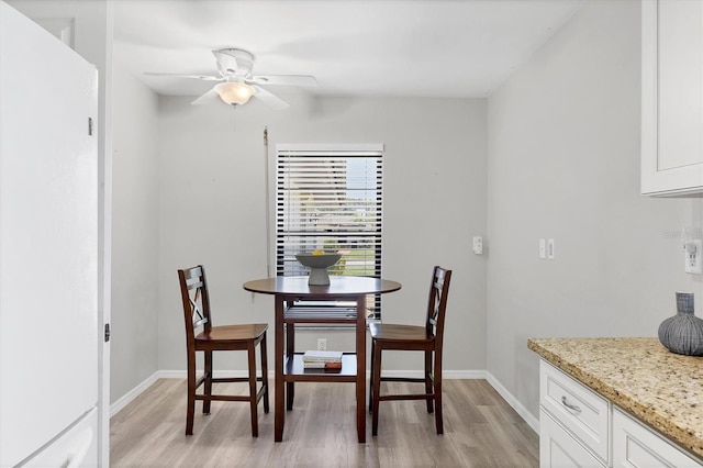 7374 Royal Birkdale Dr Unit 15D, Sarasota, FL 34238 - dining room featuring baseboards, a ceiling fan, and light wood-style flooring