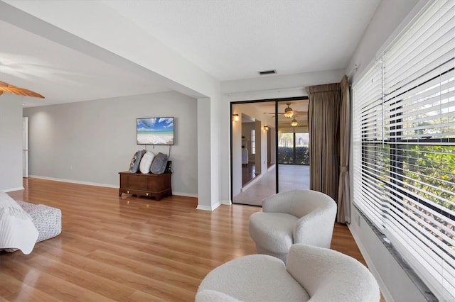 7374 Royal Birkdale Dr Unit 15D, Sarasota, FL 34238 - living room with ceiling fan, baseboards, and light wood-style floors