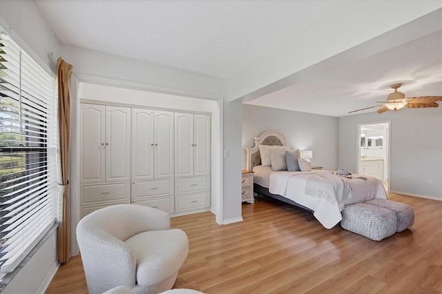 7374 Royal Birkdale Dr Unit 15D, Sarasota, FL 34238 - bedroom featuring ceiling fan, baseboards, a closet, light wood finished floors, and connected bathroom