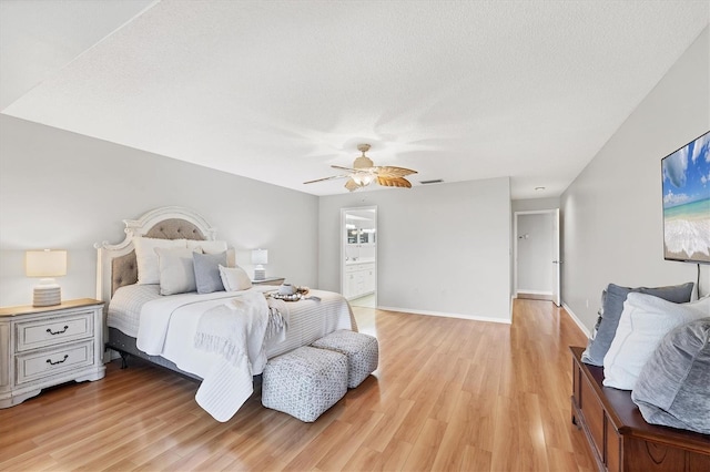 7374 Royal Birkdale Dr Unit 15D, Sarasota, FL 34238 - bedroom with ceiling fan, visible vents, light wood-type flooring, baseboards, and connected bathroom