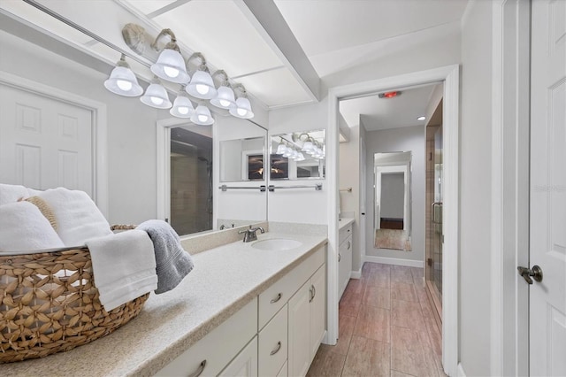 7374 Royal Birkdale Dr Unit 15D, Sarasota, FL 34238 - bathroom with baseboards, wood finished floors, a stall shower, and vanity