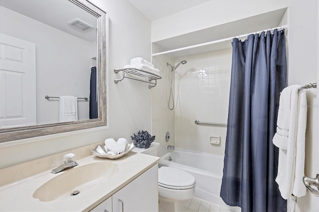 7374 Royal Birkdale Dr Unit 15D, Sarasota, FL 34238 - bathroom featuring tile patterned flooring, vanity, toilet, shower / bath combo with shower curtain, and visible vents