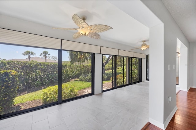 7374 Royal Birkdale Dr Unit 15D, Sarasota, FL 34238 - unfurnished room with baseboards, ceiling fan, and a healthy amount of sunlight