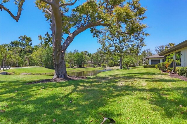 7374 Royal Birkdale Dr Unit 15D, Sarasota, FL 34238 - view of yard featuring a water view
