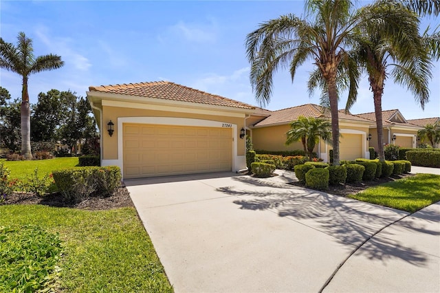 27243 Ipswich Dr, Englewood, FL 34223 - mediterranean / spanish home with a garage, a front lawn, stucco siding, and concrete driveway