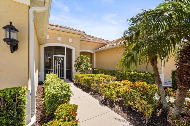 27243 Ipswich Dr, Englewood, FL 34223 - property entrance featuring stucco siding and a tile roof