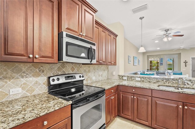 27243 Ipswich Dr, Englewood, FL 34223 - kitchen featuring a sink, appliances with stainless steel finishes, light stone counters, and visible vents