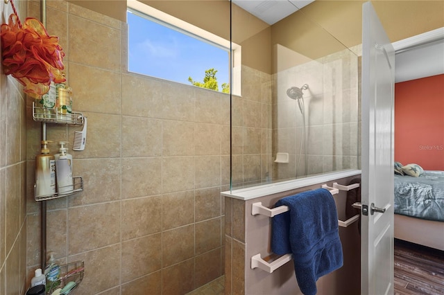 27243 Ipswich Dr, Englewood, FL 34223 - ensuite bathroom featuring walk in shower, wood finished floors, and ensuite bath