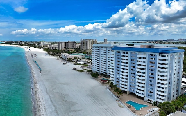 bird's eye view with a water view, a city view, and a beach view