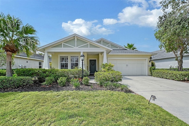 12133 Forest Park Cir, Bradenton, FL 34211 - view of front of house featuring driveway, an attached garage, stucco siding, and a front lawn