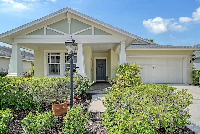12133 Forest Park Cir, Bradenton, FL 34211 - view of front of home with stucco siding, an attached garage, concrete driveway, and roof with shingles