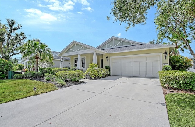 12133 Forest Park Cir, Bradenton, FL 34211 - view of front facade featuring stucco siding, driveway, an attached garage, and a front lawn