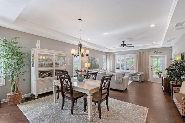 12133 Forest Park Cir, Bradenton, FL 34211 - dining room with a raised ceiling, ceiling fan, a chandelier, dark wood-style floors, and recessed lighting
