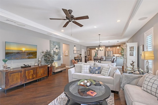12133 Forest Park Cir, Bradenton, FL 34211 - living room featuring a raised ceiling, dark wood finished floors, a ceiling fan, a chandelier, and recessed lighting
