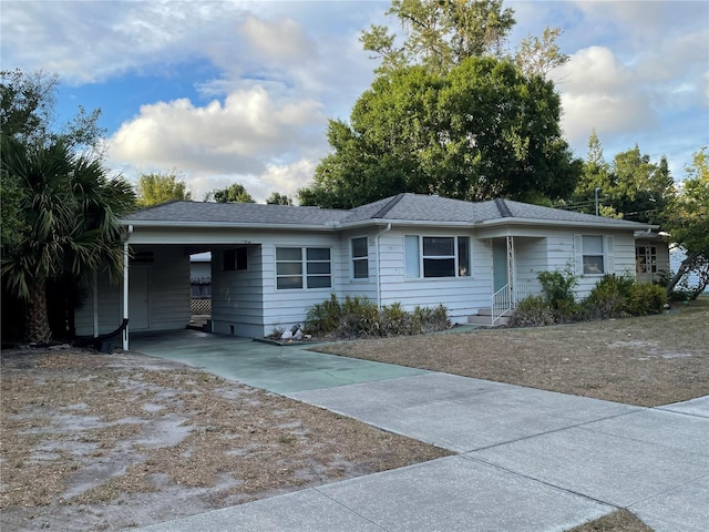 ranch-style house with driveway and a carport