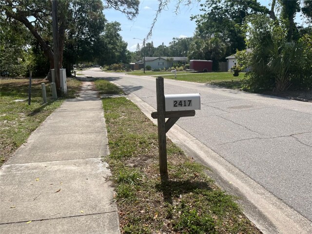 2415 Pelican Dr, Sarasota, FL 34237 - view of asphalt road featuring sidewalks and street lights