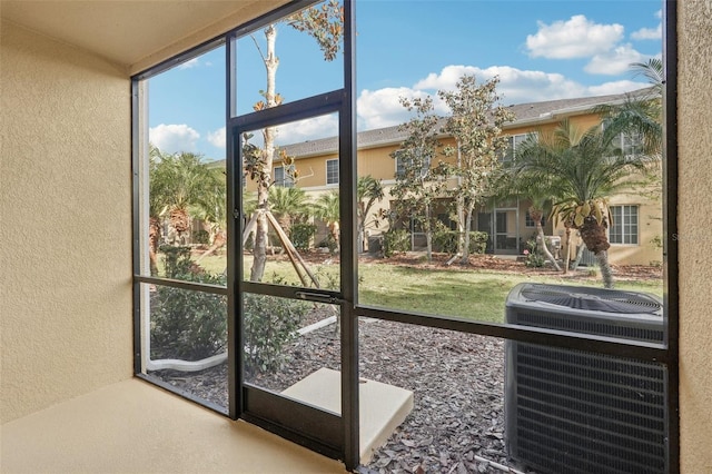 doorway to outside featuring a textured wall