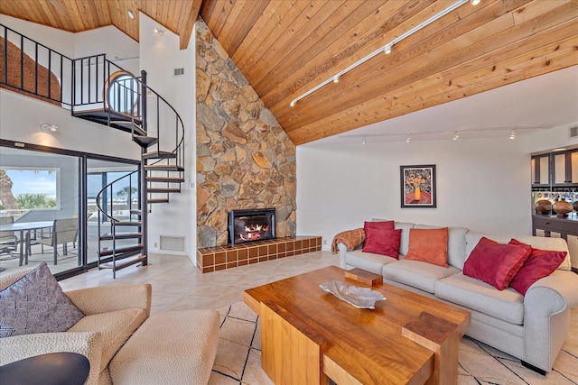 tiled living room featuring track lighting, stairway, wooden ceiling, high vaulted ceiling, and a fireplace