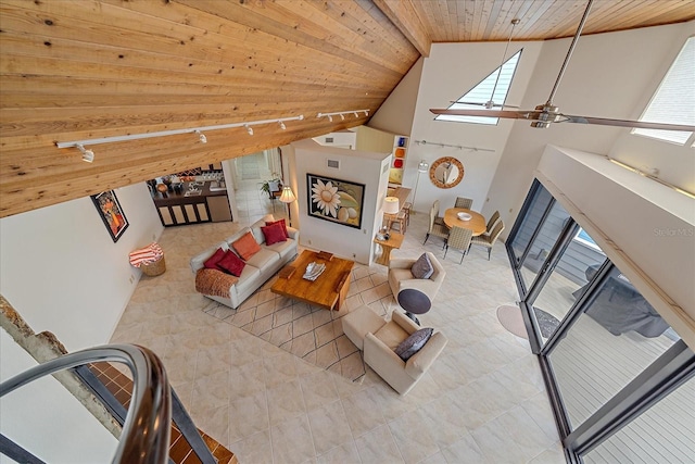 tiled living area with wood ceiling, ceiling fan, and high vaulted ceiling