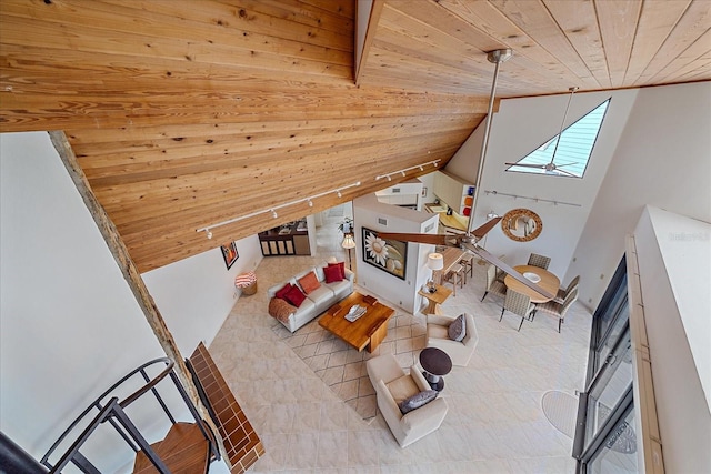 tiled living area with wood ceiling, a skylight, and vaulted ceiling