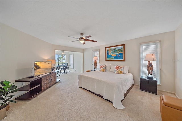 bedroom featuring carpet floors, baseboards, and ceiling fan