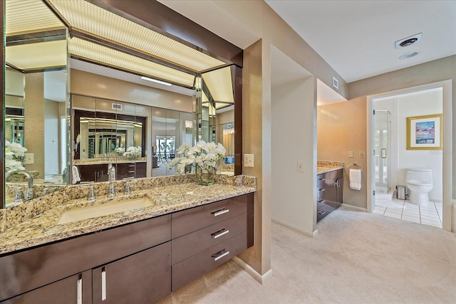 full bath with a shower stall, vanity, baseboards, and toilet