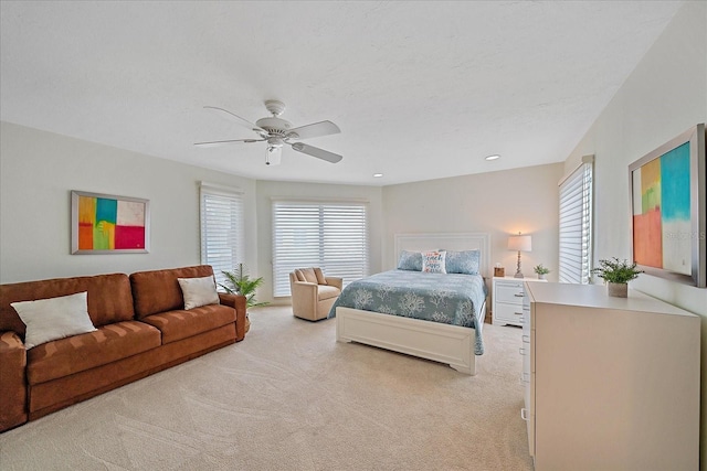 bedroom featuring light colored carpet, a ceiling fan, and recessed lighting