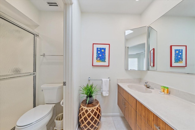 full bath with tile patterned flooring, toilet, vanity, a shower stall, and baseboards