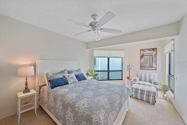 carpeted bedroom with a ceiling fan and baseboards