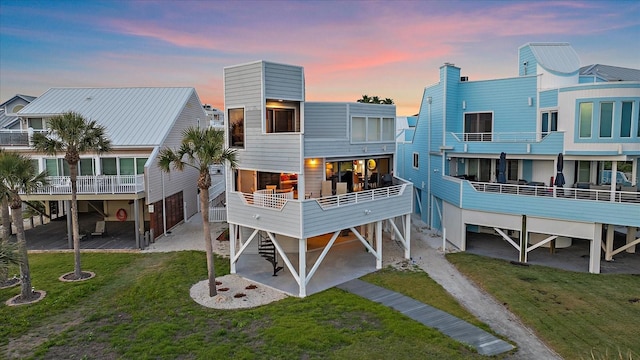 rear view of house featuring a carport and a yard