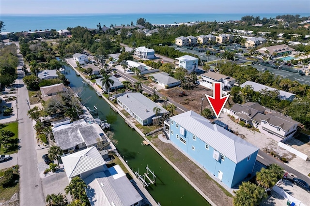 drone / aerial view with a water view and a residential view