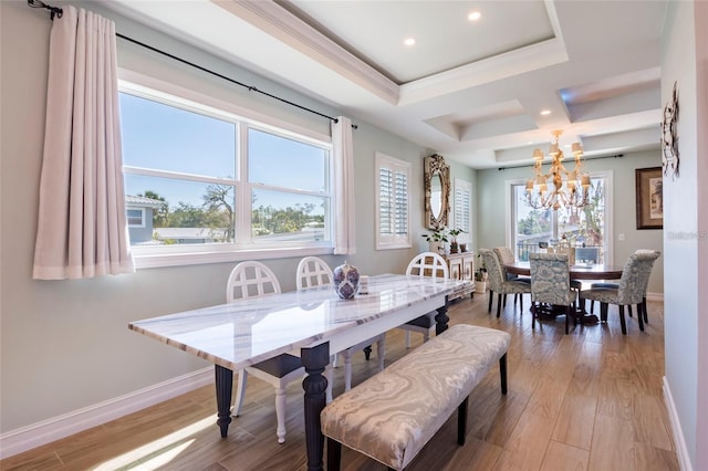 dining space featuring an inviting chandelier, baseboards, and wood finished floors