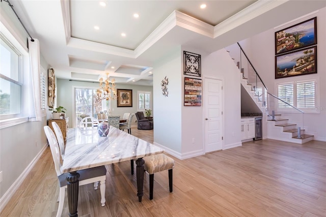 dining area featuring crown molding, stairway, light wood finished floors, a notable chandelier, and wine cooler