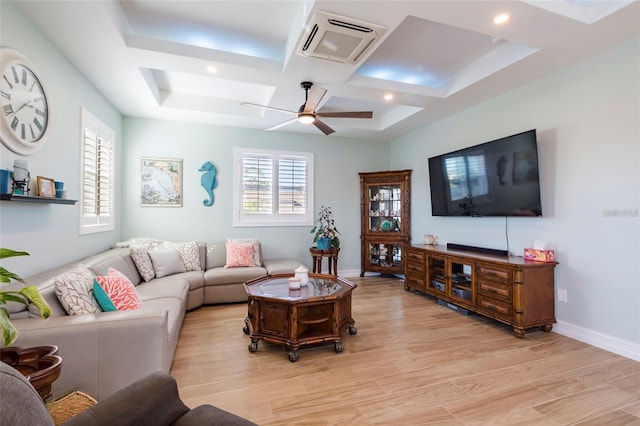 living room with ceiling fan, visible vents, plenty of natural light, and coffered ceiling