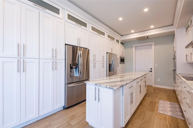 kitchen with light wood-style flooring, white cabinets, a kitchen island, and stainless steel appliances