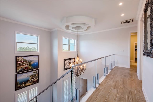 corridor with visible vents, crown molding, recessed lighting, a chandelier, and an upstairs landing