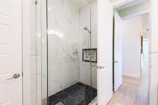 bathroom featuring a marble finish shower
