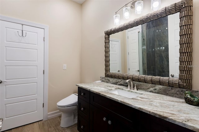 full bathroom featuring an enclosed shower, toilet, wood finished floors, and vanity