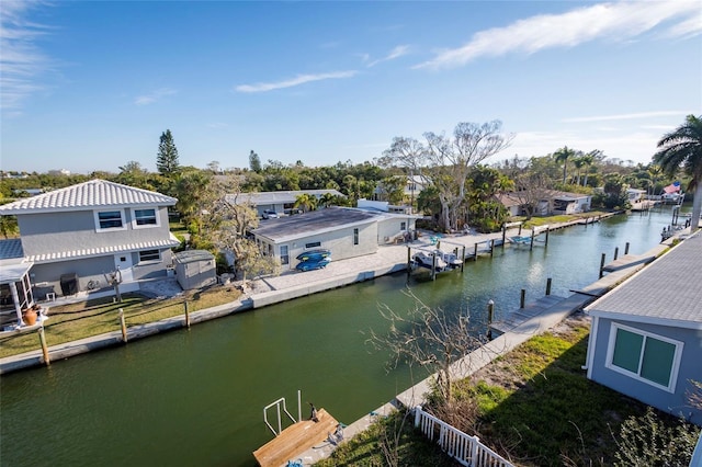 dock area featuring a water view and a residential view
