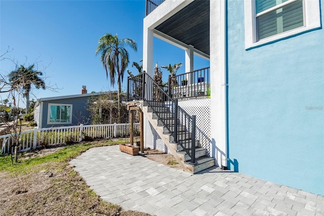 exterior space featuring fence, a patio, and stucco siding