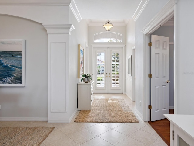 1313 Thornapple Dr, Osprey, FL 34229 - entrance foyer featuring french doors, light tile patterned floors, baseboards, ornamental molding, and an inviting chandelier